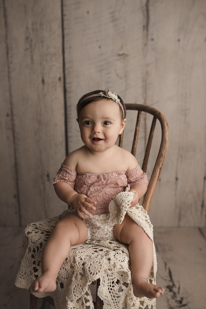 Sweet girl sitting on a wooden chair during her Indiana Milestone session.
