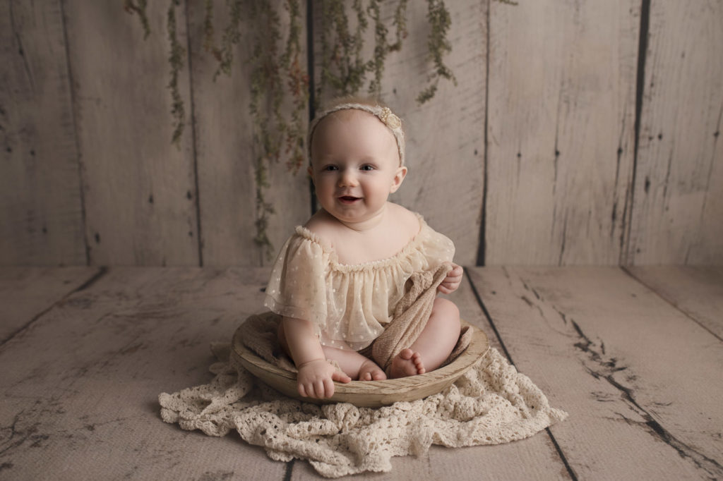 Happy little baby girl during her milestone session with her Lafayette Indiana baby photographer.