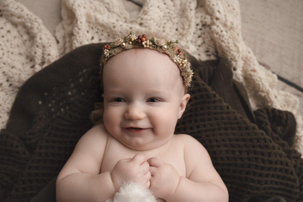 Wearing a cute floral crown during her milestone session in Indiana.