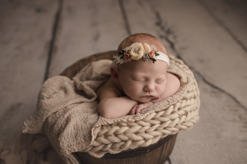 Newborn girl posed in a bucket during her West Lafayette Indiana newborn session.