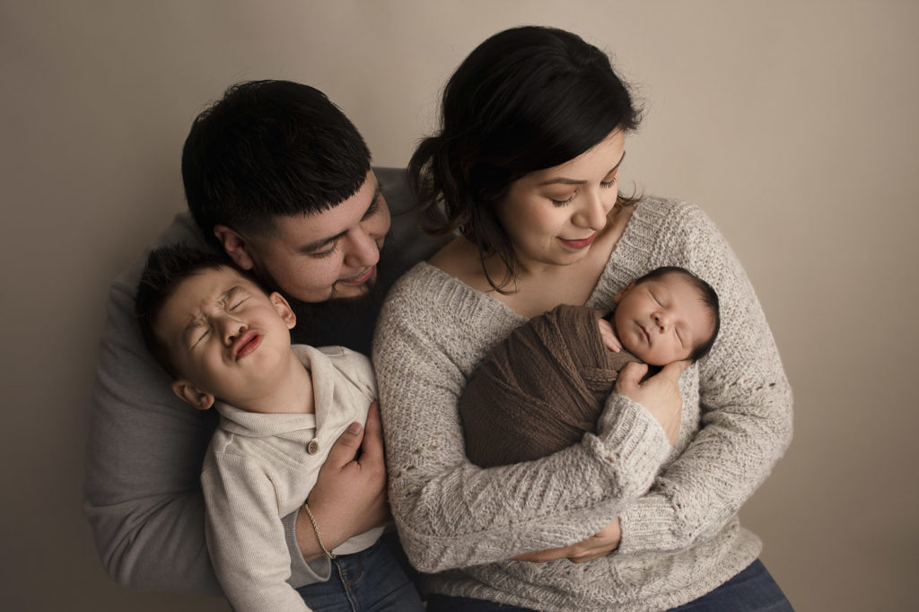 Funny family moment during a newborn session in Lafayette.