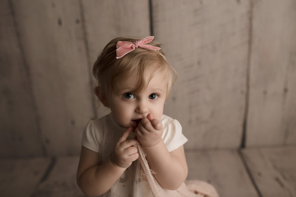 Pretty little girl posing during her first birthday photography session in Lafayette Indiana.