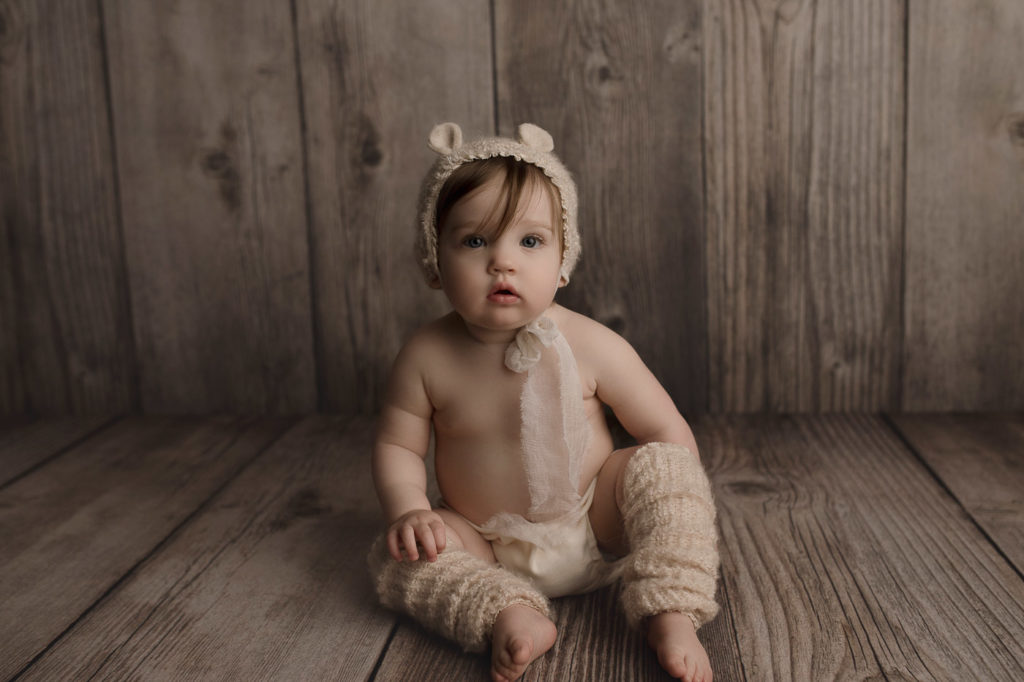 Cutest little baby bear posing at her birthday photo session in a Lafayette Indiana studio