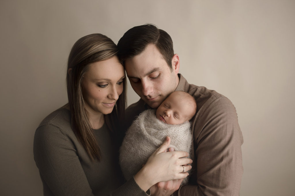 Mom and dad posed with new baby boy during their Indiana newborn session.
