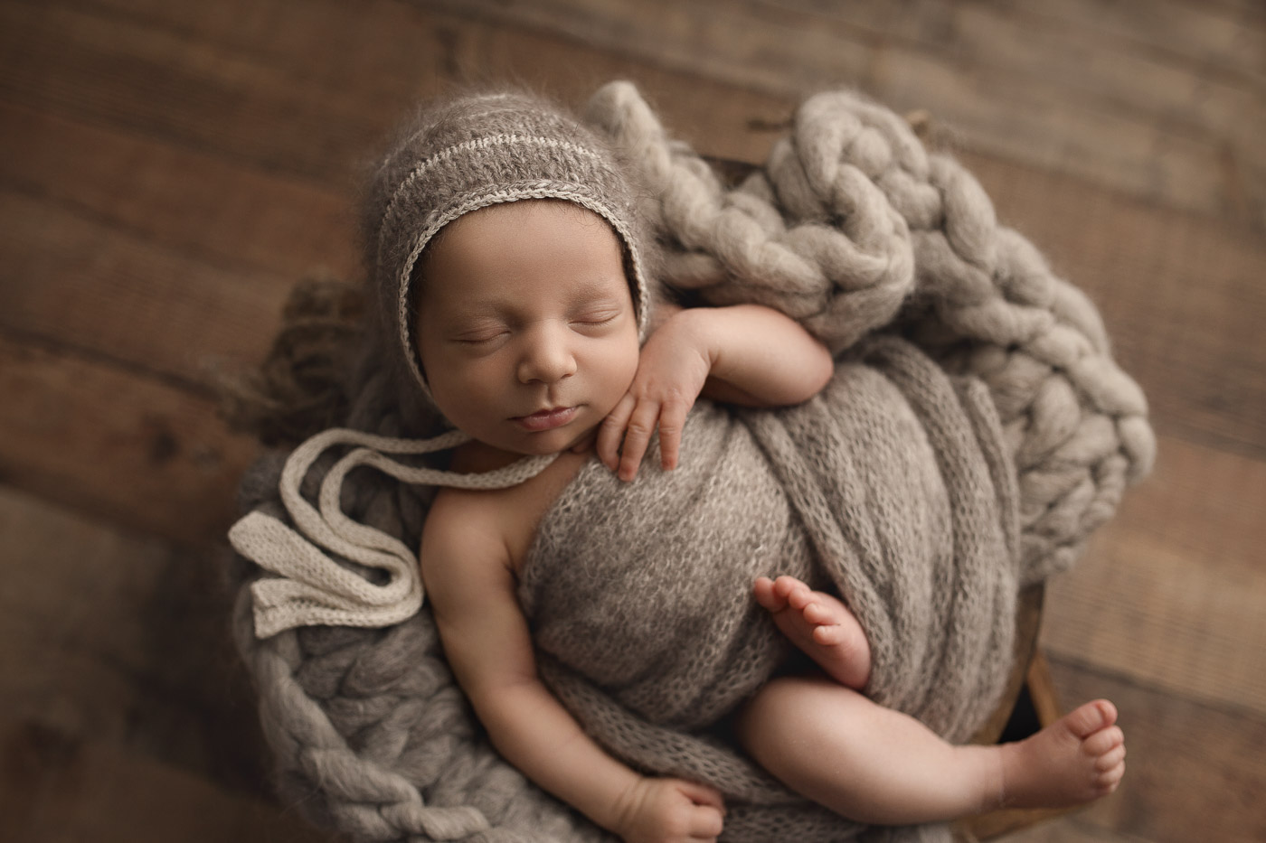 Cute relaxed baby boy in a bowl at his Lafayette Indiana studio session.