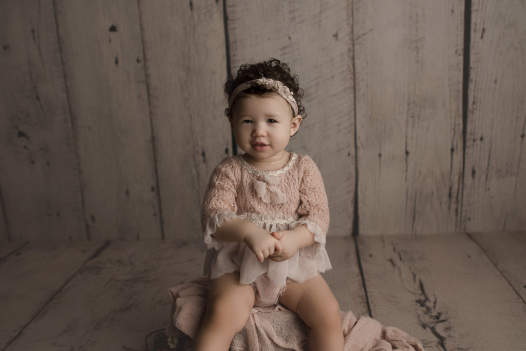 Sweet girl posing at her studio milestone session in Lafayette Indiana.