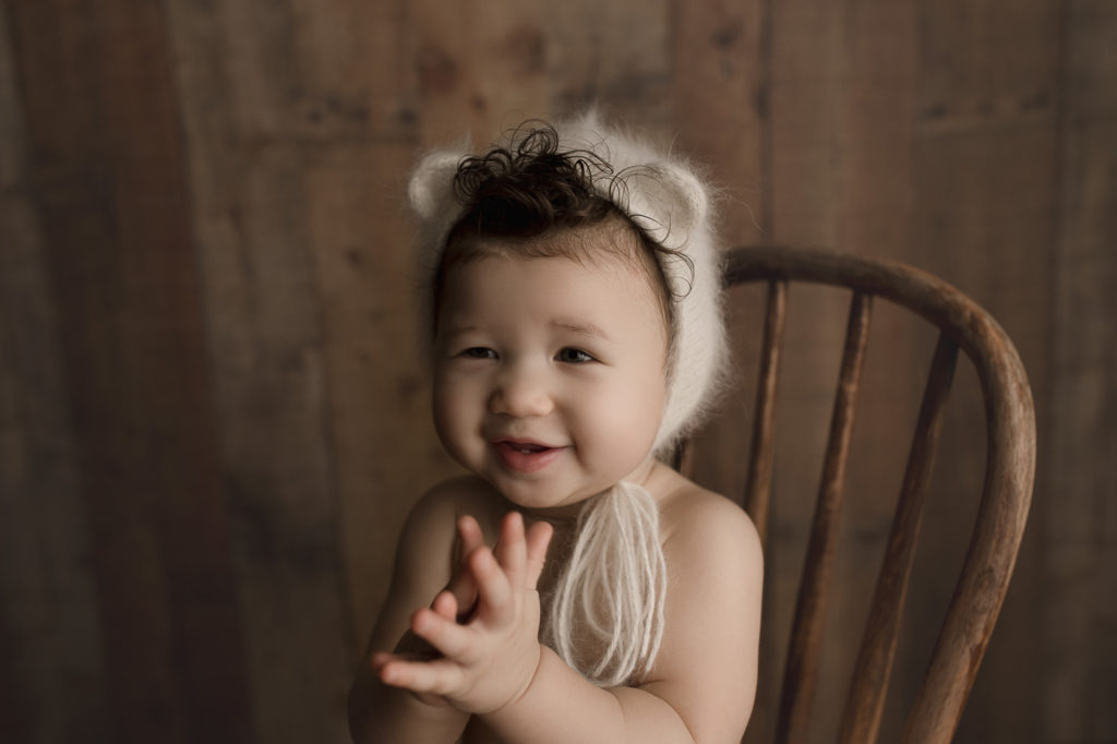 Such a precious little girl clapping at her milestone session in Lafayette.