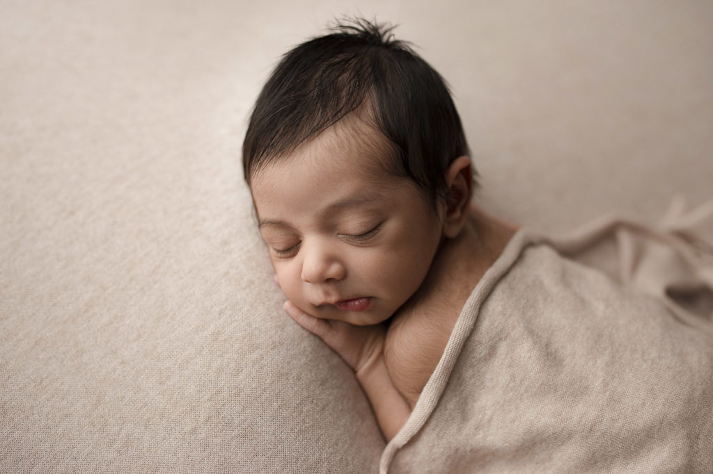 Sleeping baby boy at his newborn photography session.