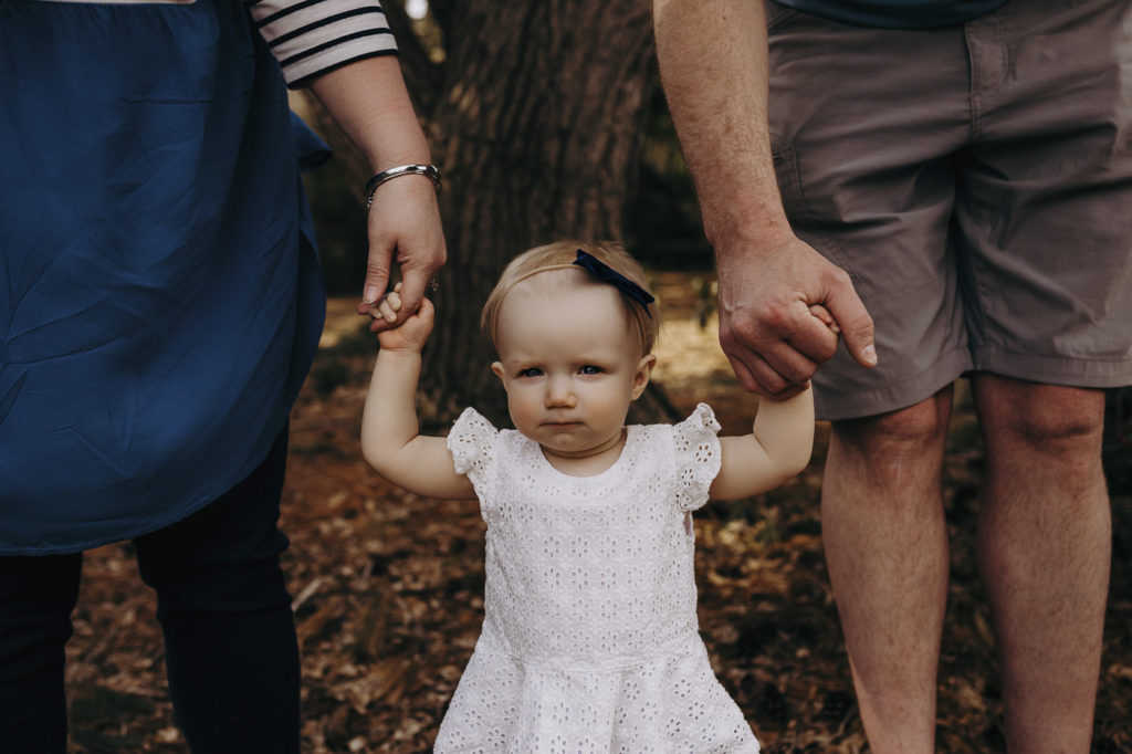 Holding hands with mom and dad during a photography session.