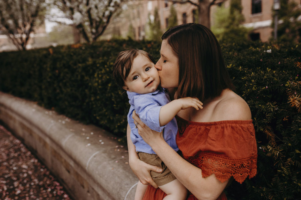 Mom giving her little son some sweet kisses at their family session on Purdue's campus.