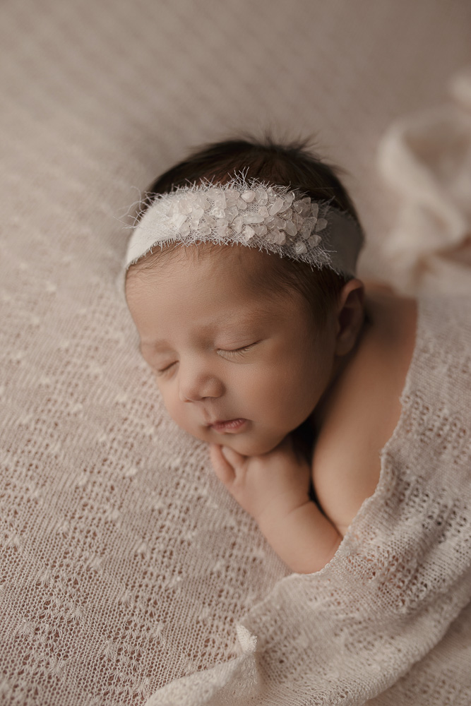 Cute view of baby girl's profile during her newborn session.