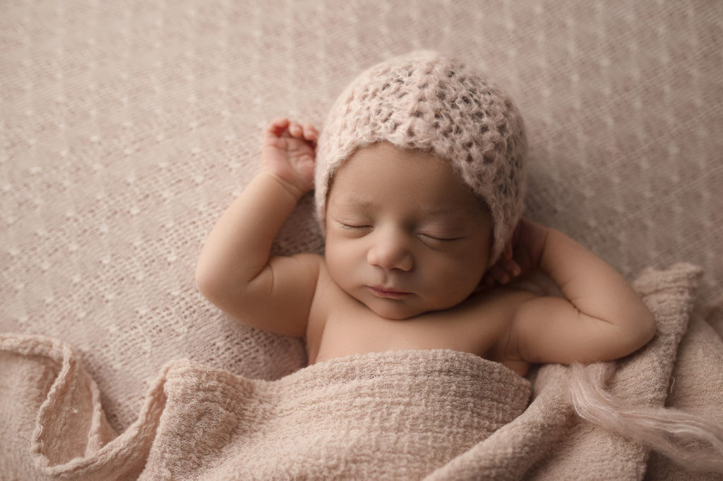 Relaxed baby girl sleeping at her studio newborn session in Lafayette.