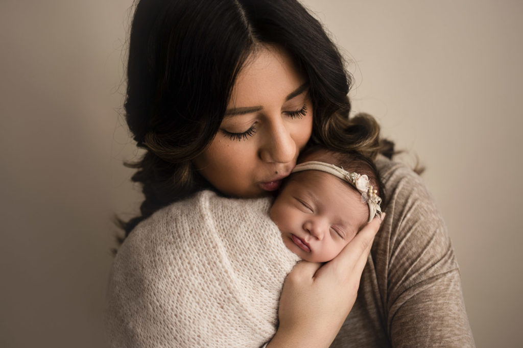 Mom and baby girl sharing a sweet moment during her Lafayette Indiana newborn photography session.