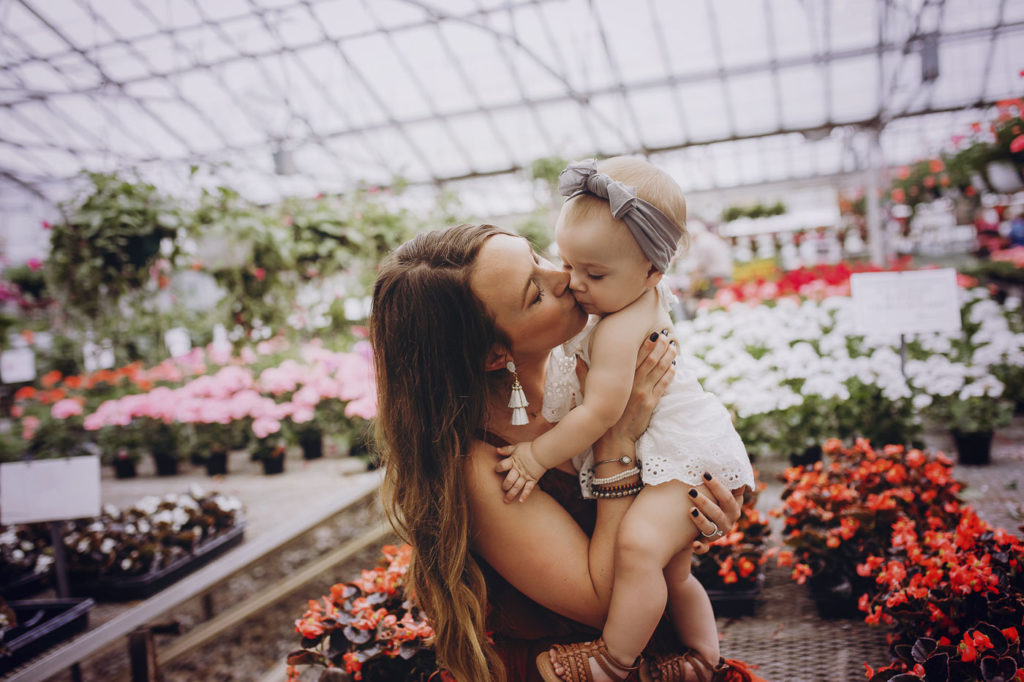 Mom giving little girl kisses during their photography session.