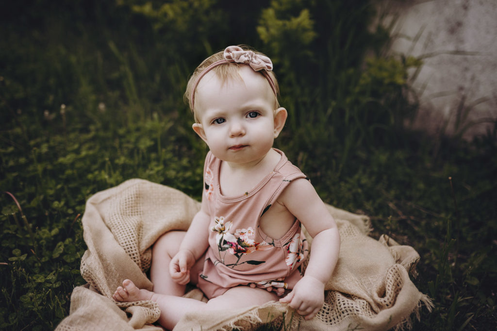 One year old girl in a bowl at her milestone session in Indiana.
