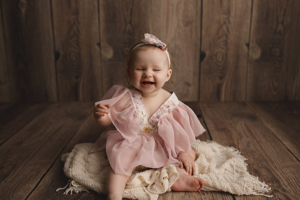 Cute baby girl laughing during her session in Lafayette Indiana.