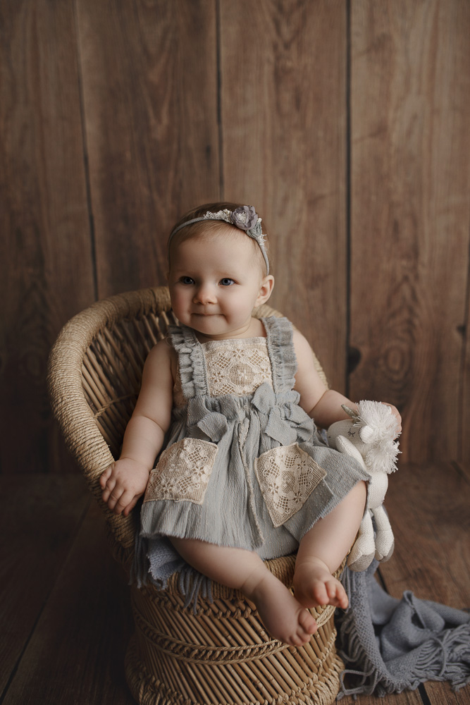 Little girl in an antique chair in a Lafayette Indiana studio.