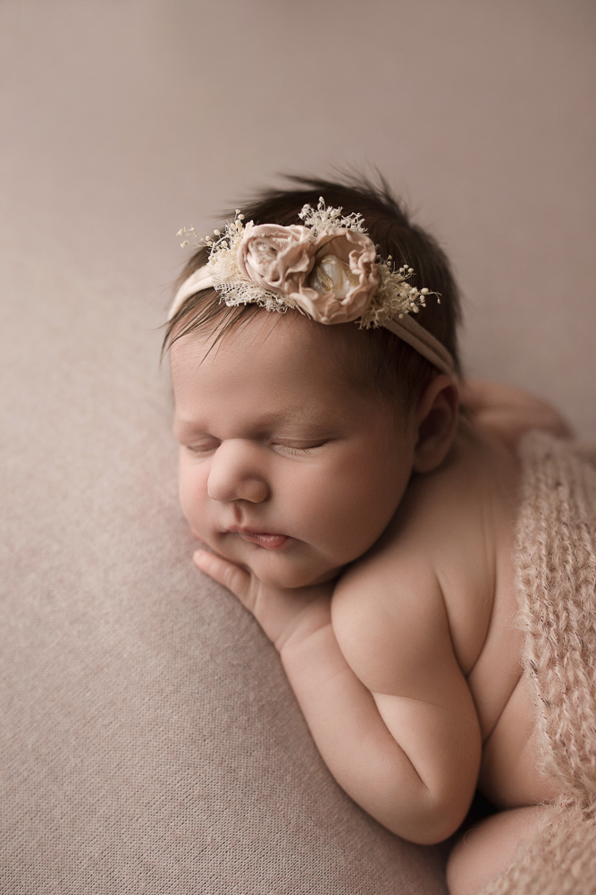 Baby girl with pink headband for her newborn session.
