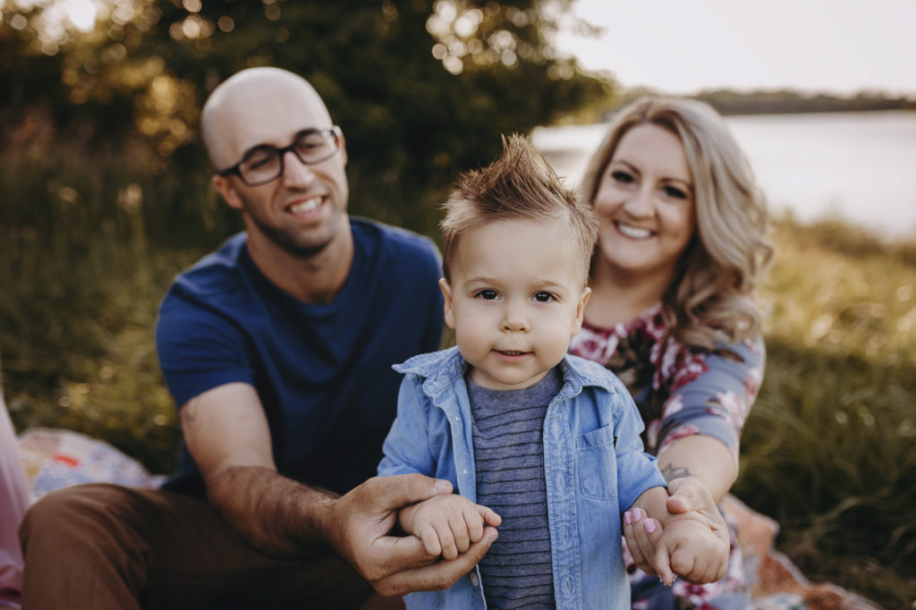 Mom and dad with their one year old son for his milestone session.