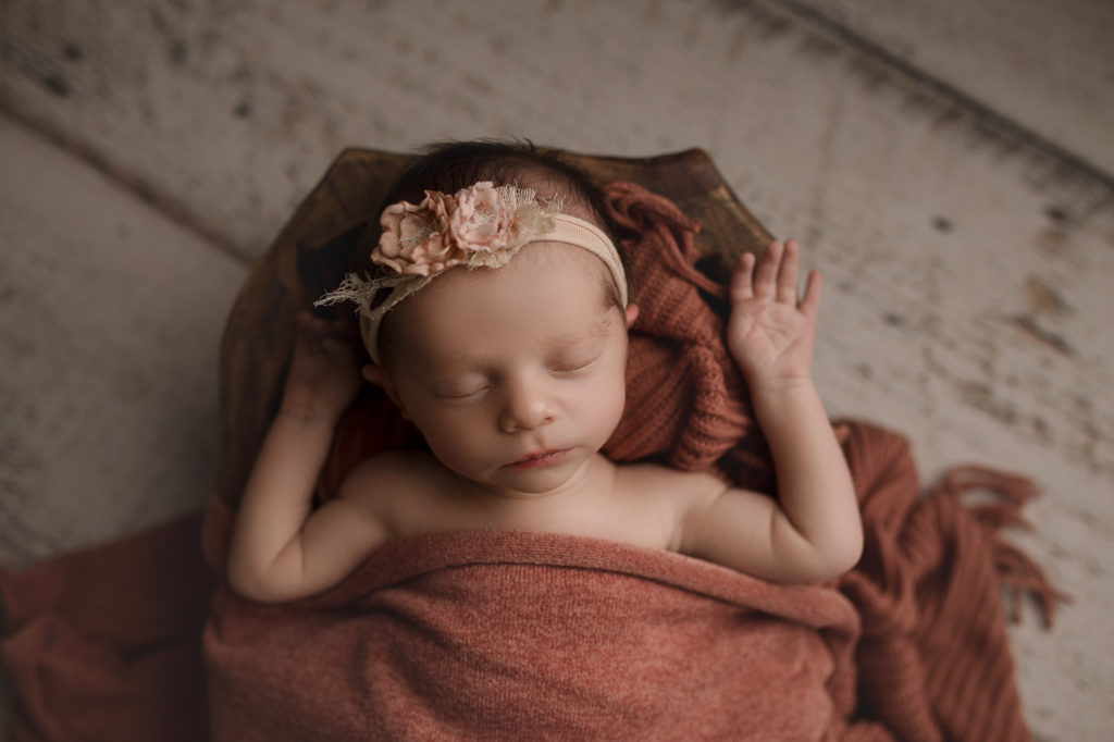 Relaxed posing of a sweet baby girl at her Indiana studio newborn session.