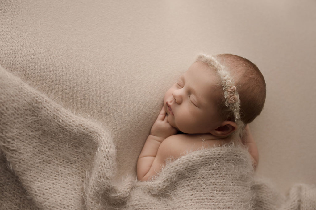 Posed sleeping baby girl with beautiful headband during Lafayette Indiana newborn session.