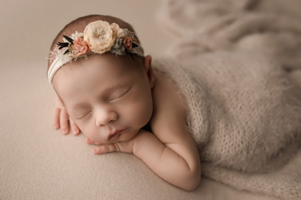 Adorable newborn with floral headband.