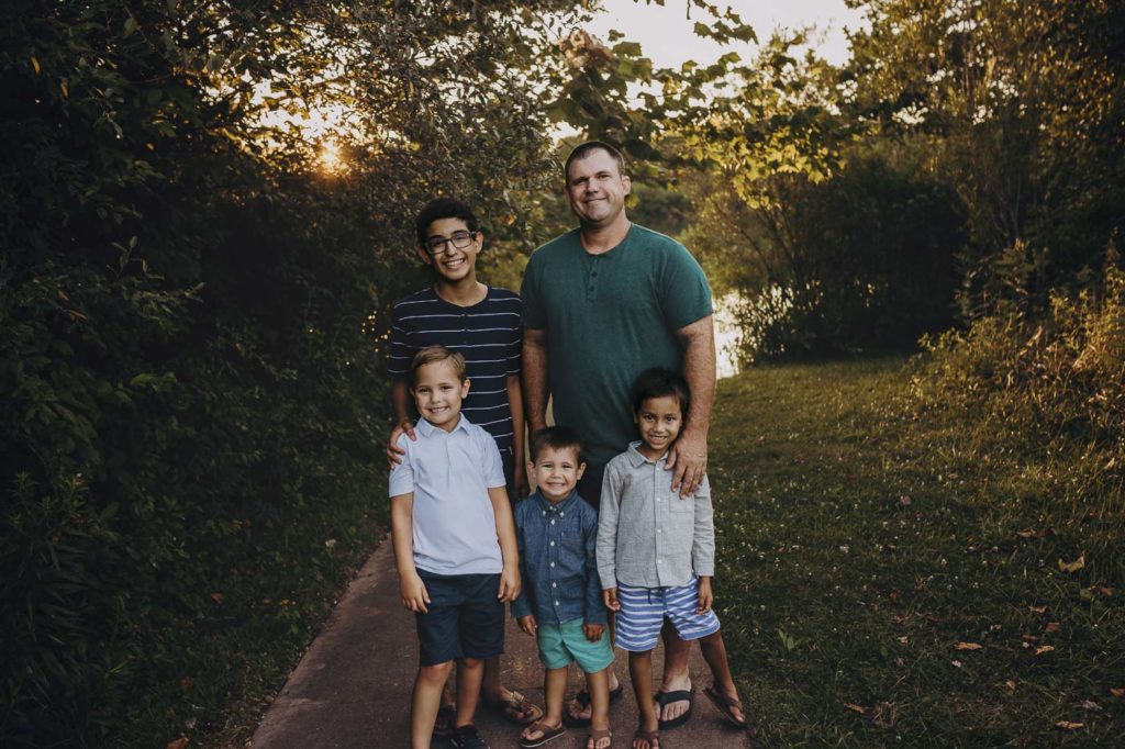 A dad with his boys at their Indiana family session outdoors.
