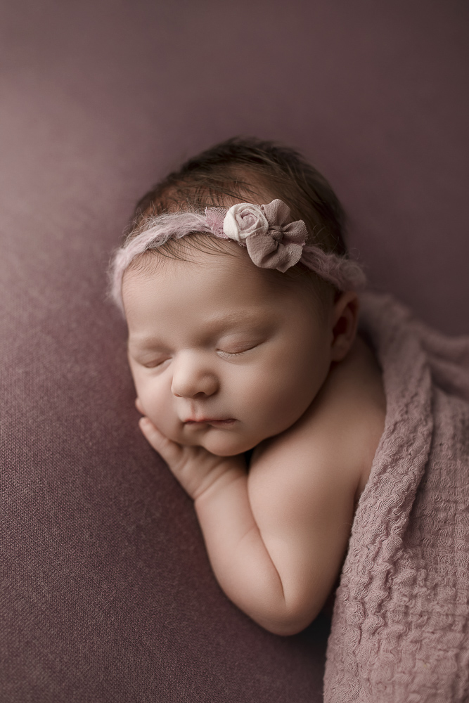 Cute newborn girl sleeping at her studio session in Lafayette Indiana.
