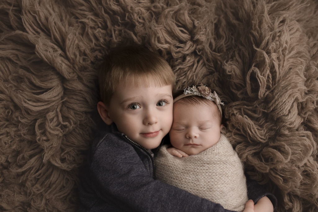 Cute siblings posed together at an West Lafayette Indiana newborn session.