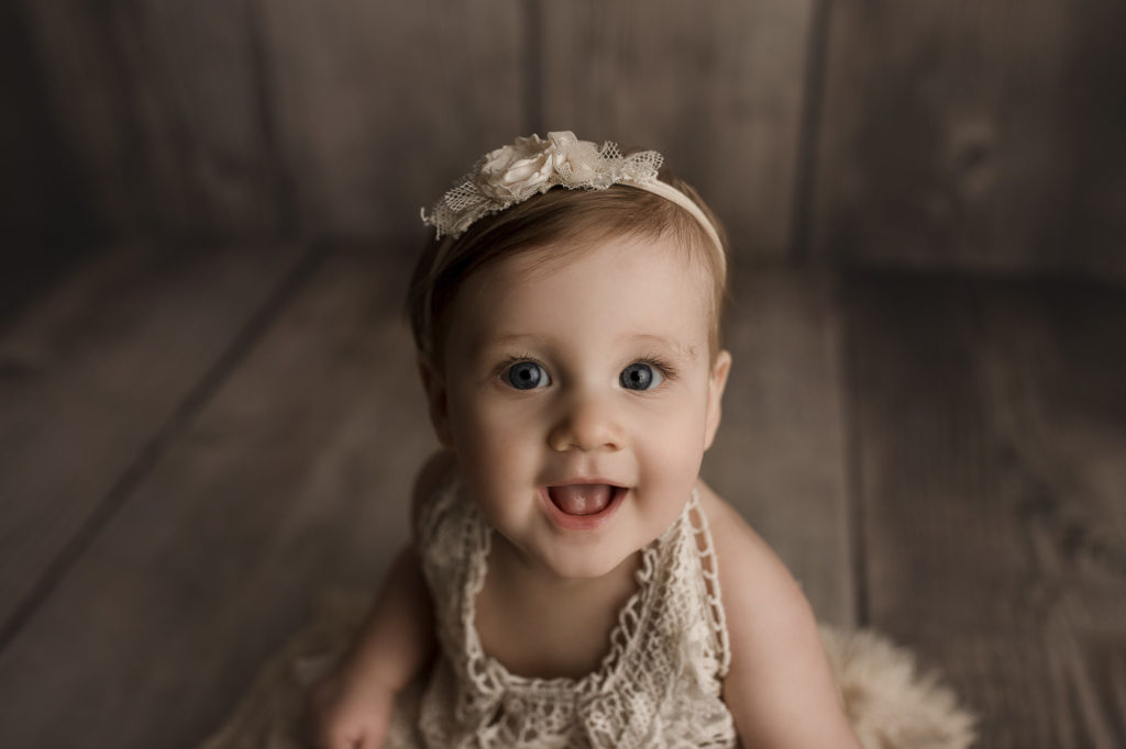 Lovely little girl smiling at her  Lafayette baby milestone session.