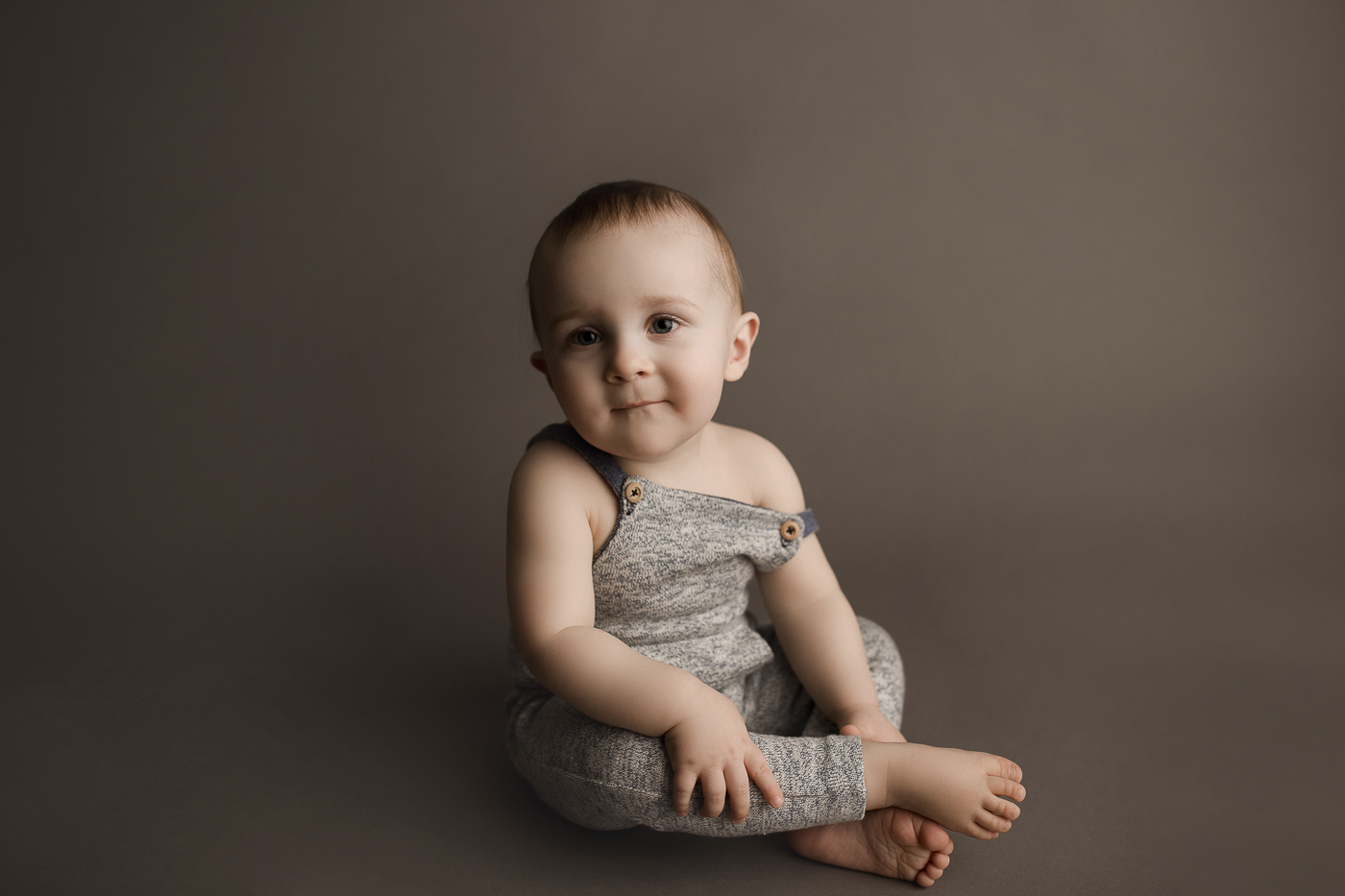 Sweet baby boy posing during his one year studio milestone session.