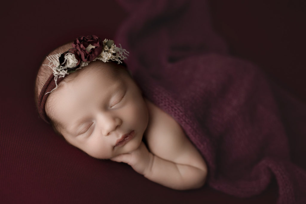 Baby girl sleeping during her newborn photography session in West Lafayette Indiana.